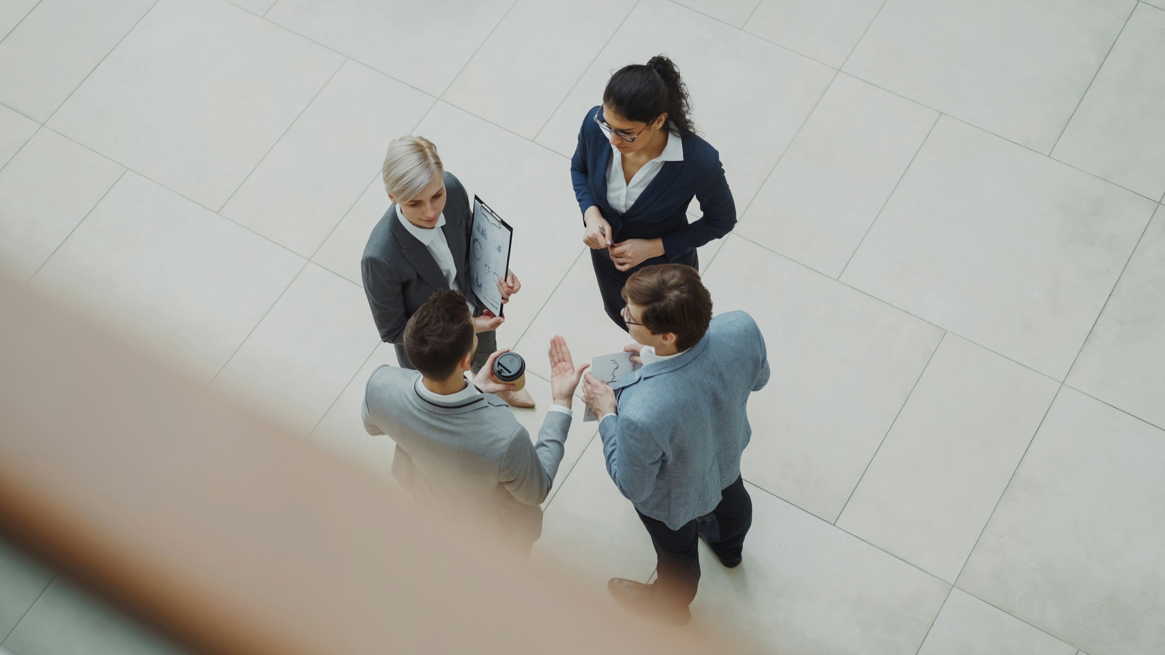 Top-down view of a leadership team in conversation over a document